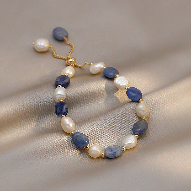 Blue Sandstone & Pearl Bracelet featuring deep blue sandstone and freshwater pearls with gold-tone spacer details.