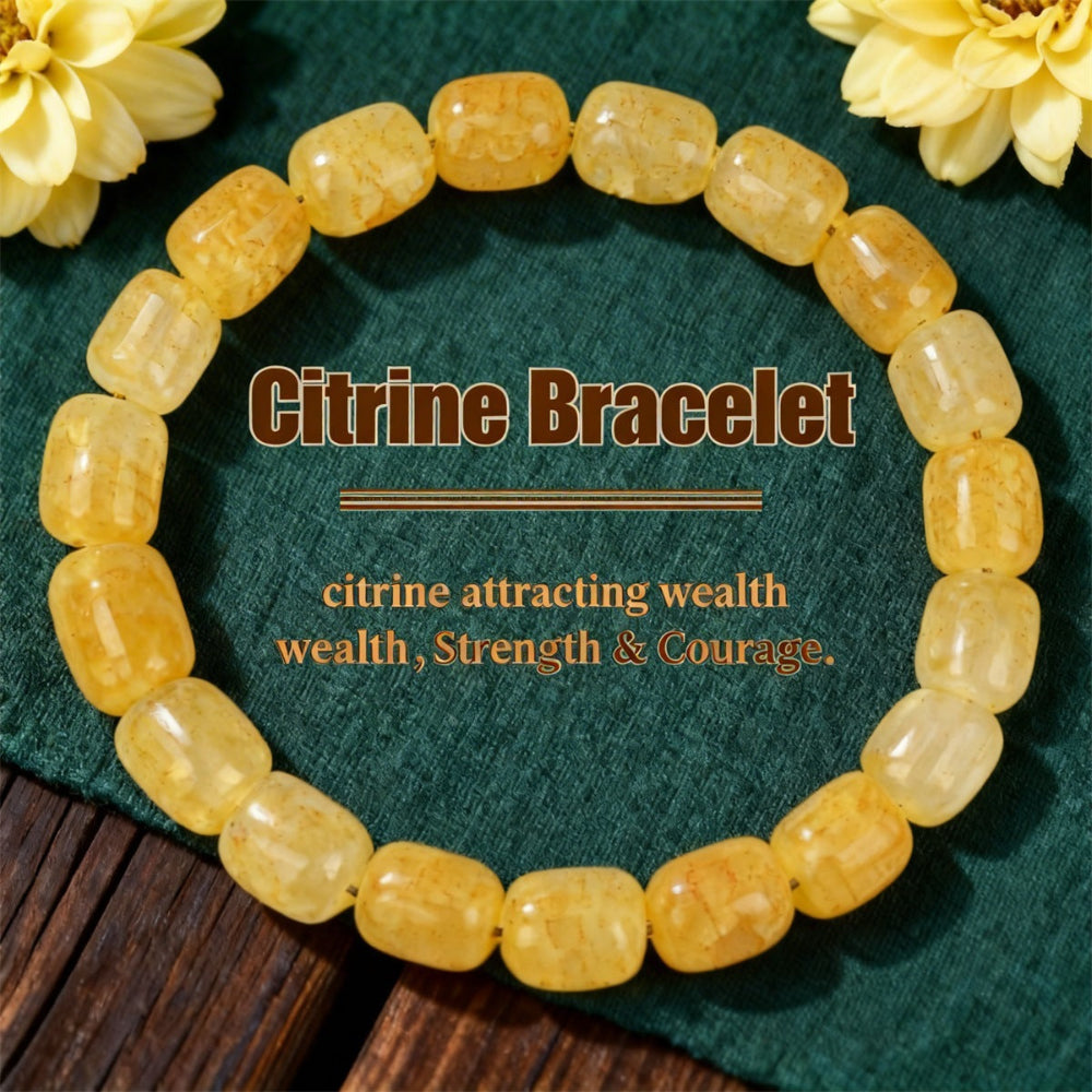 Natural Citrine Barrel Bead Bracelet on a deep green velvet surface, hand-strung with smooth polished golden-yellow citrine quartz in a rounded barrel shape