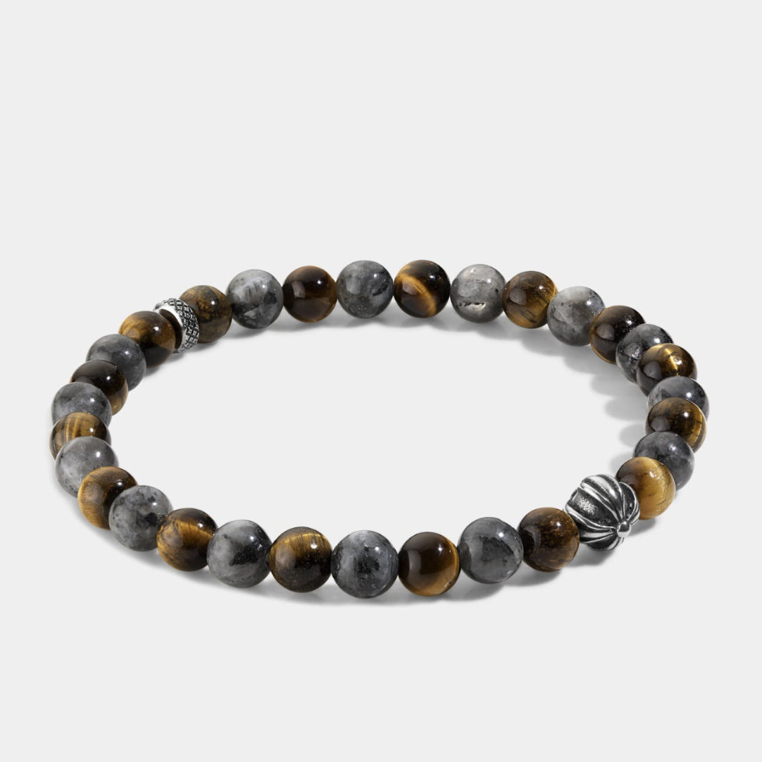 Close-up of natural tiger eye hawk eye stone bracelet showing polished round beads with chatoyant golden-brown tiger eye, blue-grey hawk eye natural stone surface and handcrafted silver accent beads, elastic structure.
