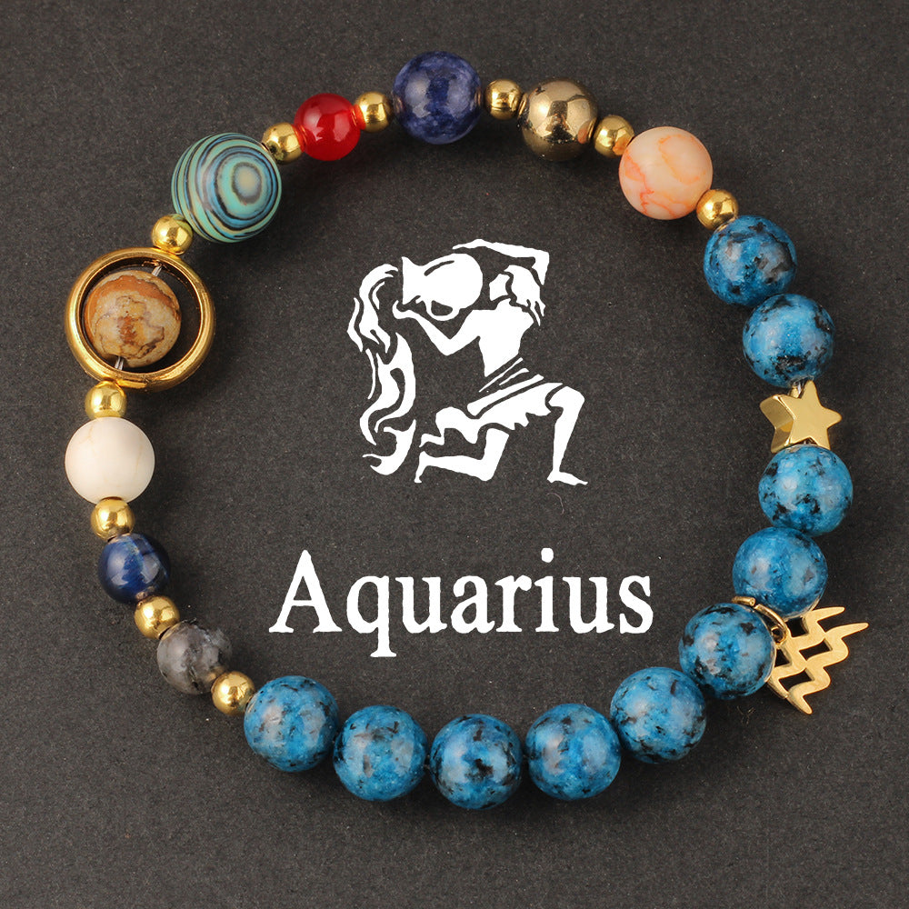 Side view of Natural zodiac stone bracelet showing Saturn ring charm and elastic cord closure with deep ocean beads.