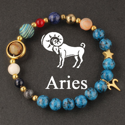 Side view of Natural zodiac stone bracelet showing Saturn ring charm and elastic cord closure with deep ocean beads.