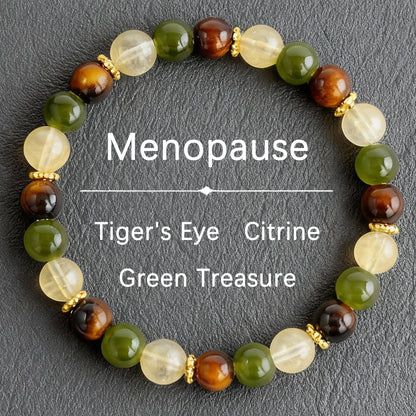 Natural tiger eye crystal stone bracelet showing three-color alternating beads — warm golden-brown chatoyant tiger eye, deep forest green stone and pale apple green translucent crystal on elastic cord