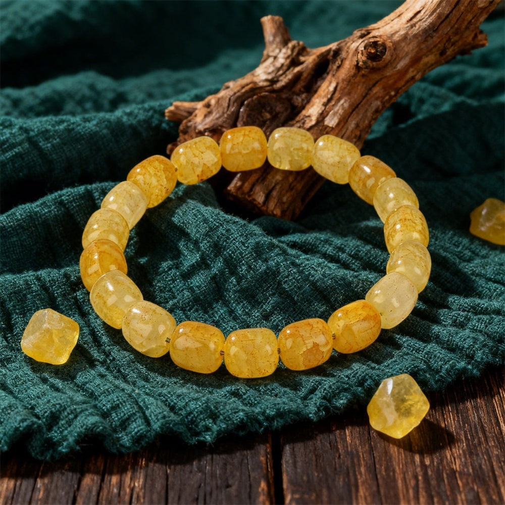 Natural Citrine Barrel Bead Bracelet resting beside a soft ceramic cup and dried yellow flowers, styled as a warm daily stacker for women who love citrine jewelry