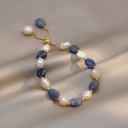 Blue Sandstone &amp; Pearl Bracelet featuring deep blue sandstone and freshwater pearls with gold-tone spacer details.
