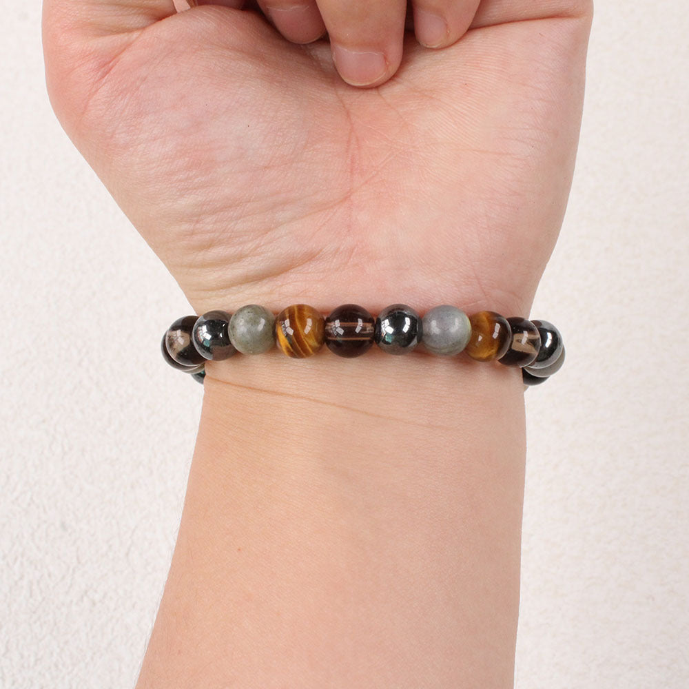 Close-up of Natural Tiger Eye Black Onyx Labradorite Bracelet, focusing on the trio of tiger eye, black onyx and labradorite beads sitting side by side