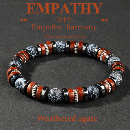 Natural cracked agate wood bracelet hand-strung in a single loop, alternating crackled black agate rounds with warm brown rosewood beads, displayed on dark linen