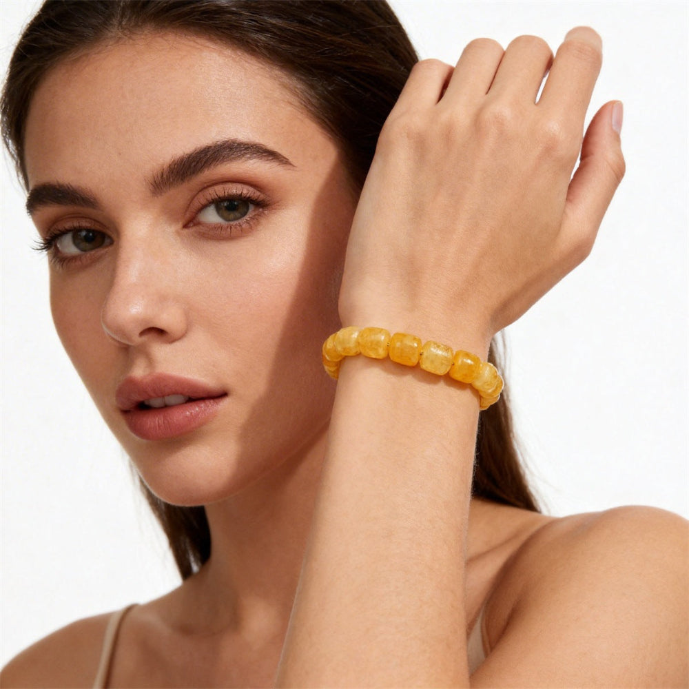 Natural Citrine Barrel Bead Bracelet shown from a second angle, emphasizing the soft stretch cord loop and the warm honey to amber shading across each barrel bead 