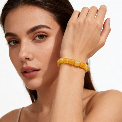 Natural Citrine Barrel Bead Bracelet shown from a second angle, emphasizing the soft stretch cord loop and the warm honey to amber shading across each barrel bead 