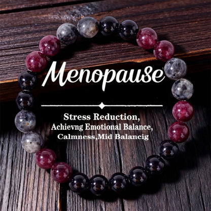 Natural Garnet Black Onyx Smoky Crystal Bracelet on a warm weathered wood surface, hand-strung with deep garnet red, smooth black onyx and translucent smoky beads