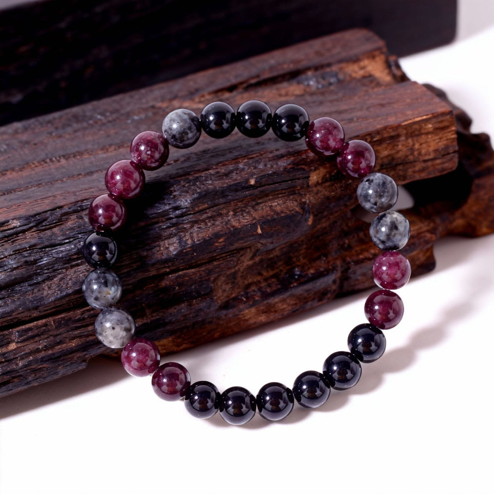 Close-up of Natural Garnet Black Onyx Smoky Crystal Bracelet, focusing on the trio of garnet red, black onyx and smoky inclusion beads sitting side by side