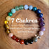  Multi-Color Natural Crystal Stone Bracelet on a warm wood surface, hand-strung with eighteen polished natural stone beads spanning yellow, pink, red, violet, blue, green and teal in one circle 