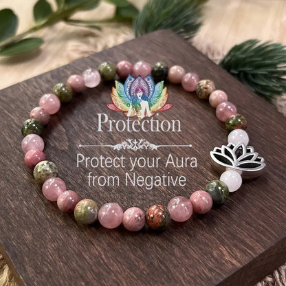  Natural Pink Crystal Lotus Bracelet shown from a second angle, highlighting the silver lotus charm sitting beside a clean white spacer stone on the soft stretch cord loop