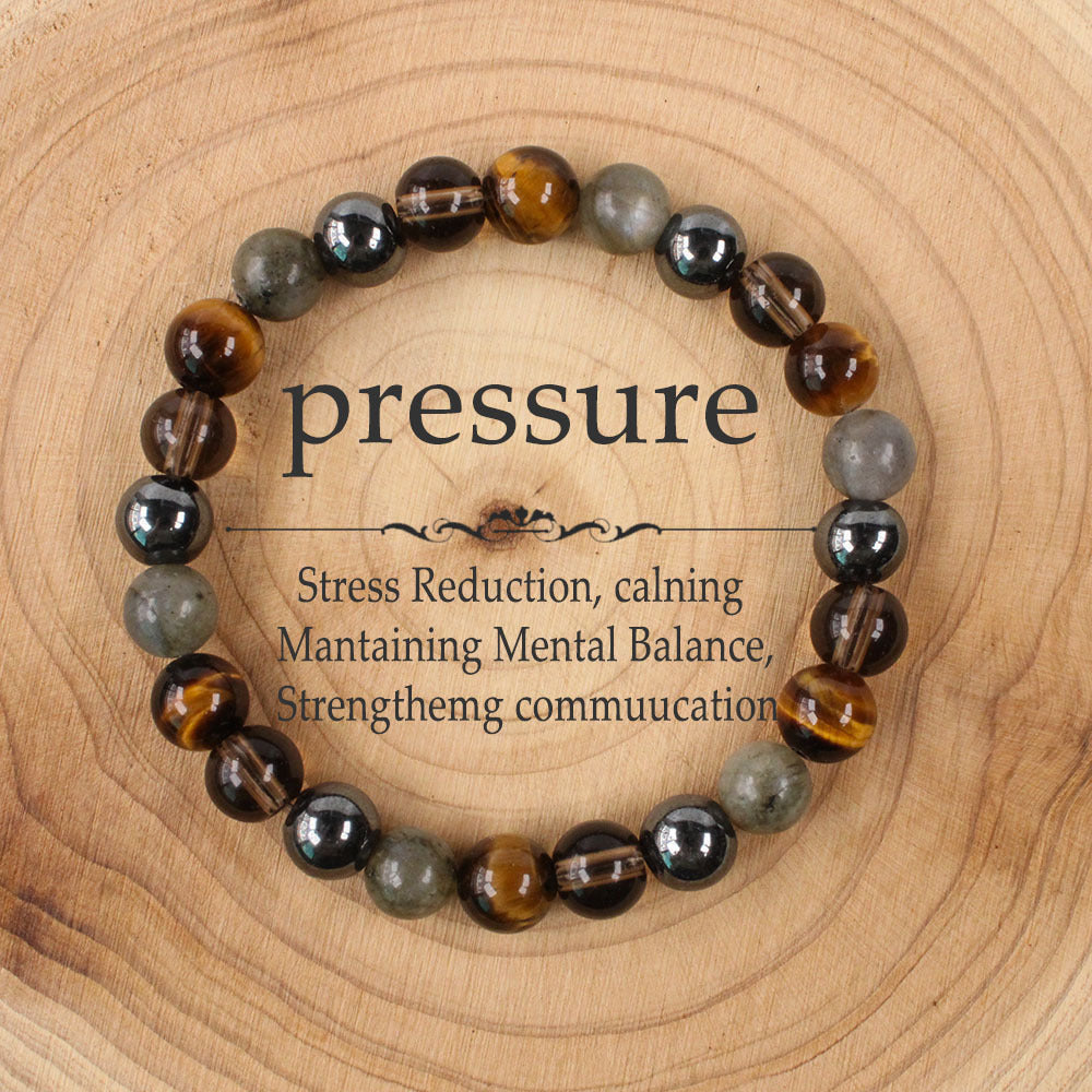 Natural Tiger Eye Black Onyx Labradorite Bracelet on a warm wood plate, hand-strung with golden tiger eye, deep black onyx and flash grey labradorite beads