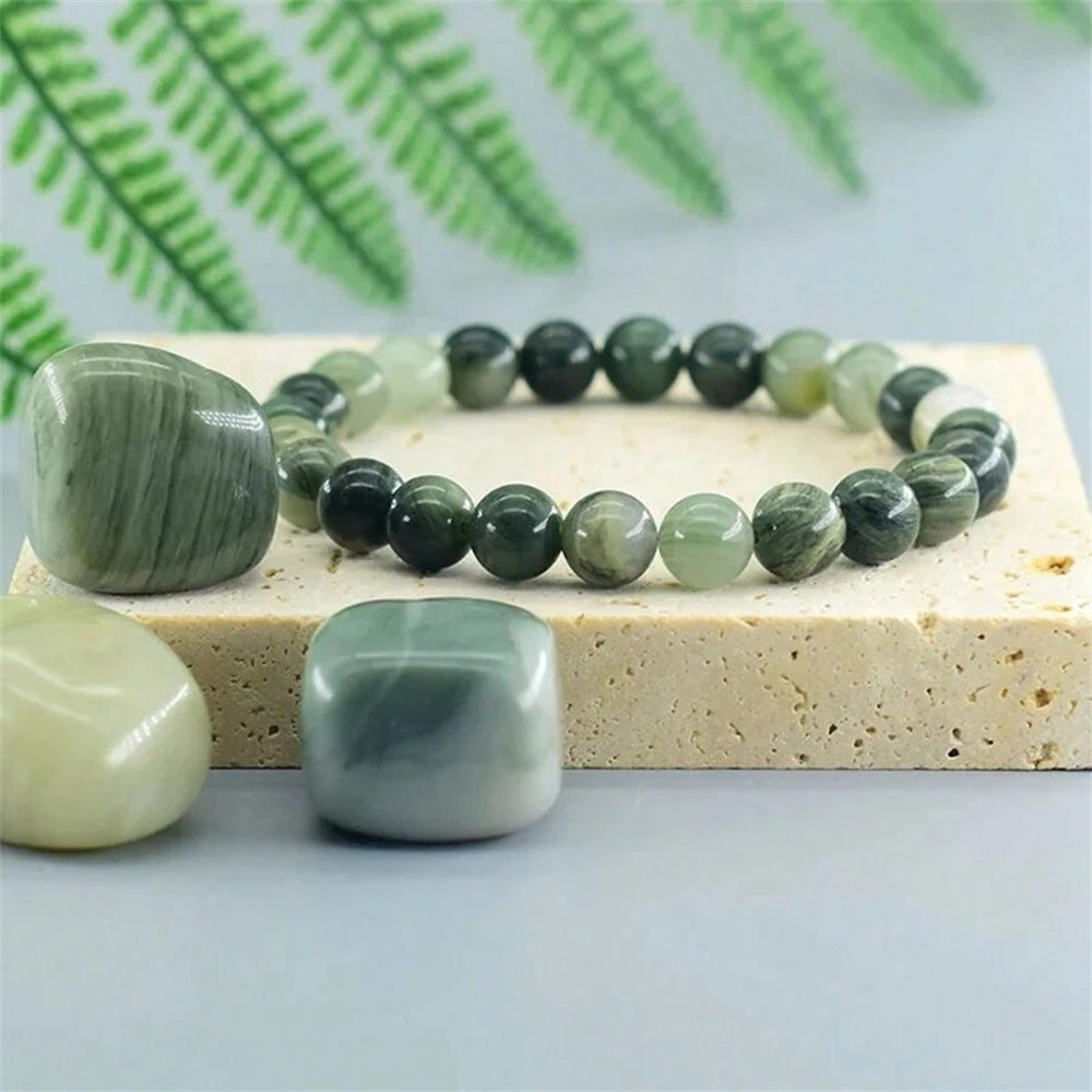  Natural Green Jade Cat Eye Bracelet shown from a second angle, emphasizing the soft stretch cord loop and the deep forest green shading across the heavier beads