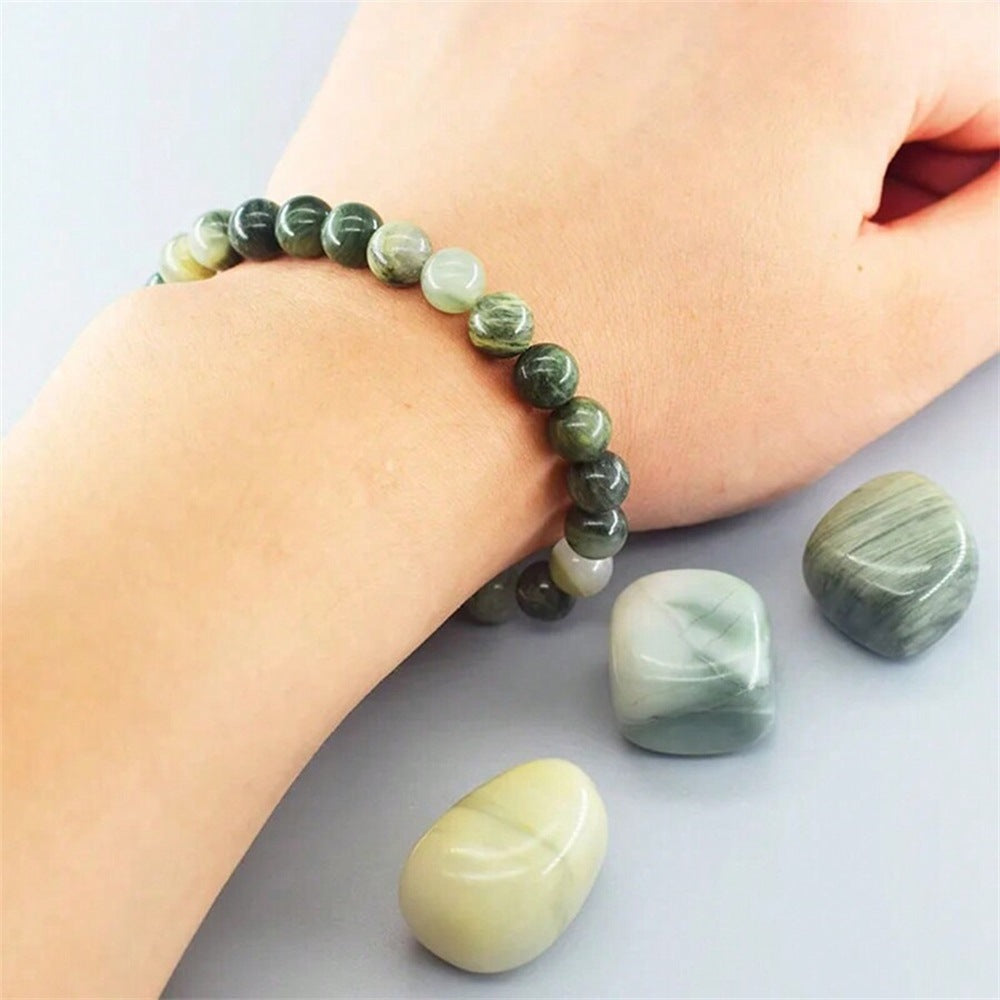  Natural Green Jade Cat Eye Bracelet shown from a second angle, emphasizing the soft stretch cord loop and the deep forest green shading across the heavier beads