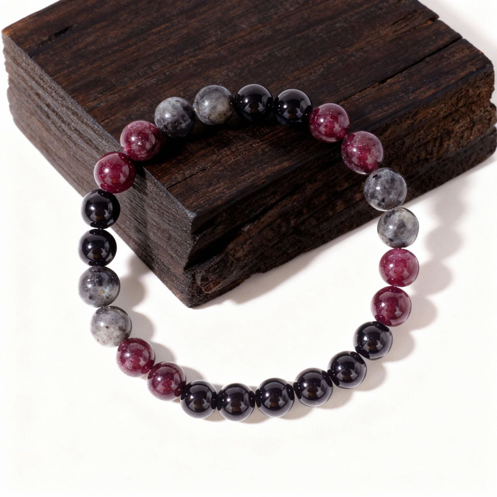 Close-up of Natural Garnet Black Onyx Smoky Crystal Bracelet, focusing on the trio of garnet red, black onyx and smoky inclusion beads sitting side by side