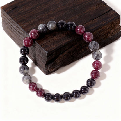 Close-up of Natural Garnet Black Onyx Smoky Crystal Bracelet, focusing on the trio of garnet red, black onyx and smoky inclusion beads sitting side by side