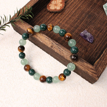 Natural tiger eye crystal stone bracelet with polished round beads alternating in warm golden-brown tiger eye, deep forest green stone and pale apple green crystal, hand-knotted on elastic cord, earthy crystal jewelry for women and men.