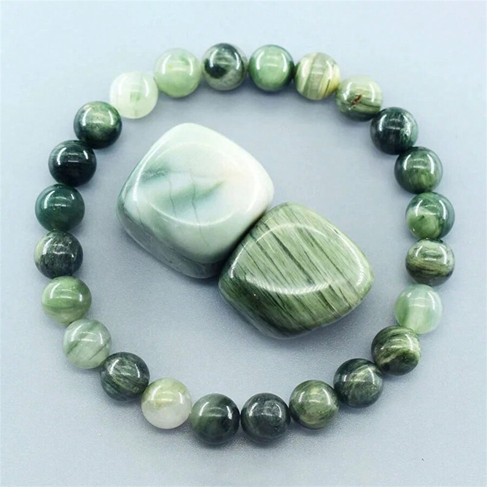 Close-up of Natural Green Jade Cat Eye Bracelet, focusing on the chatoyant cat&
