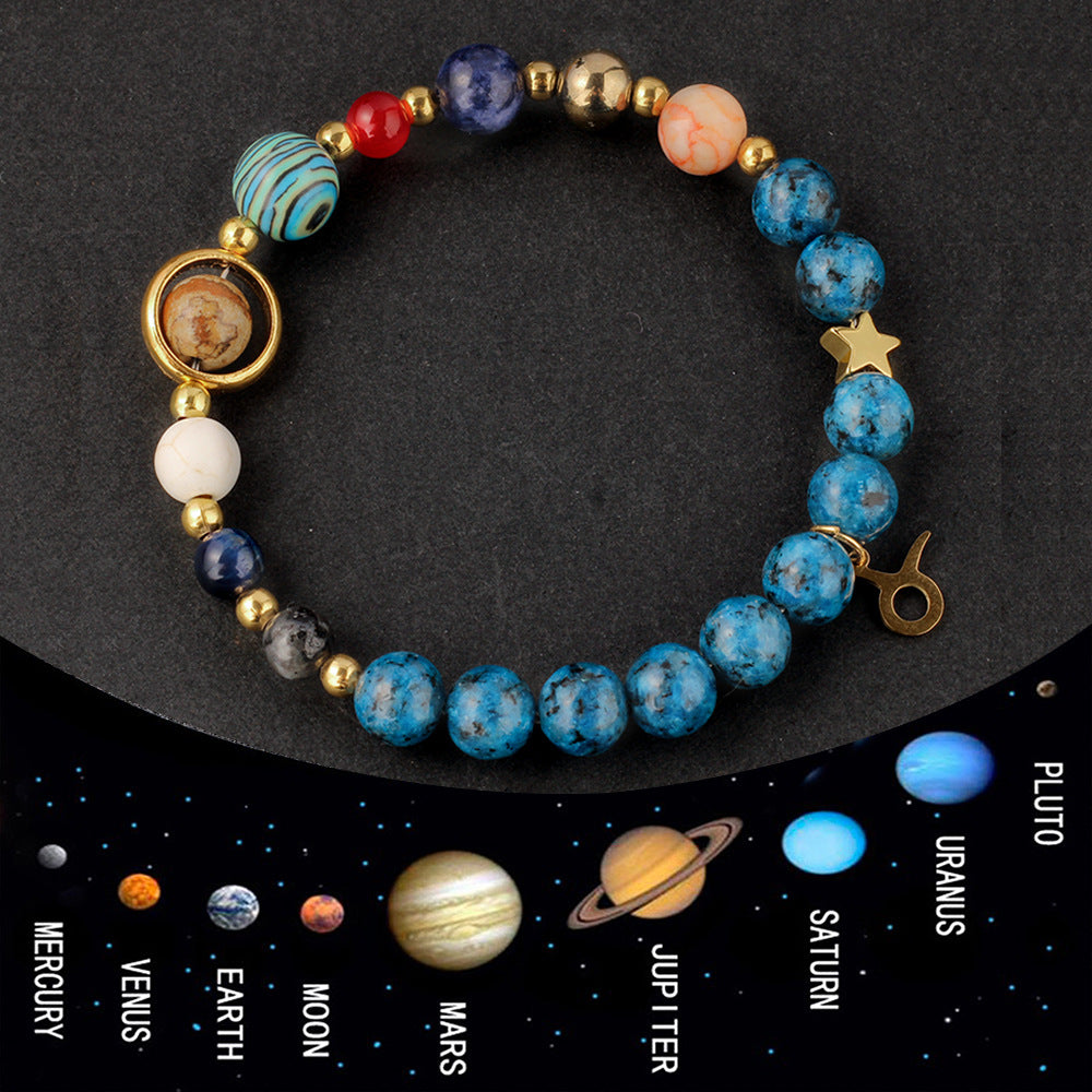 Natural zodiac stone bracelet hand-knotted with deep sea blue speckled beads and gold Aquarius charm, on clean white background.